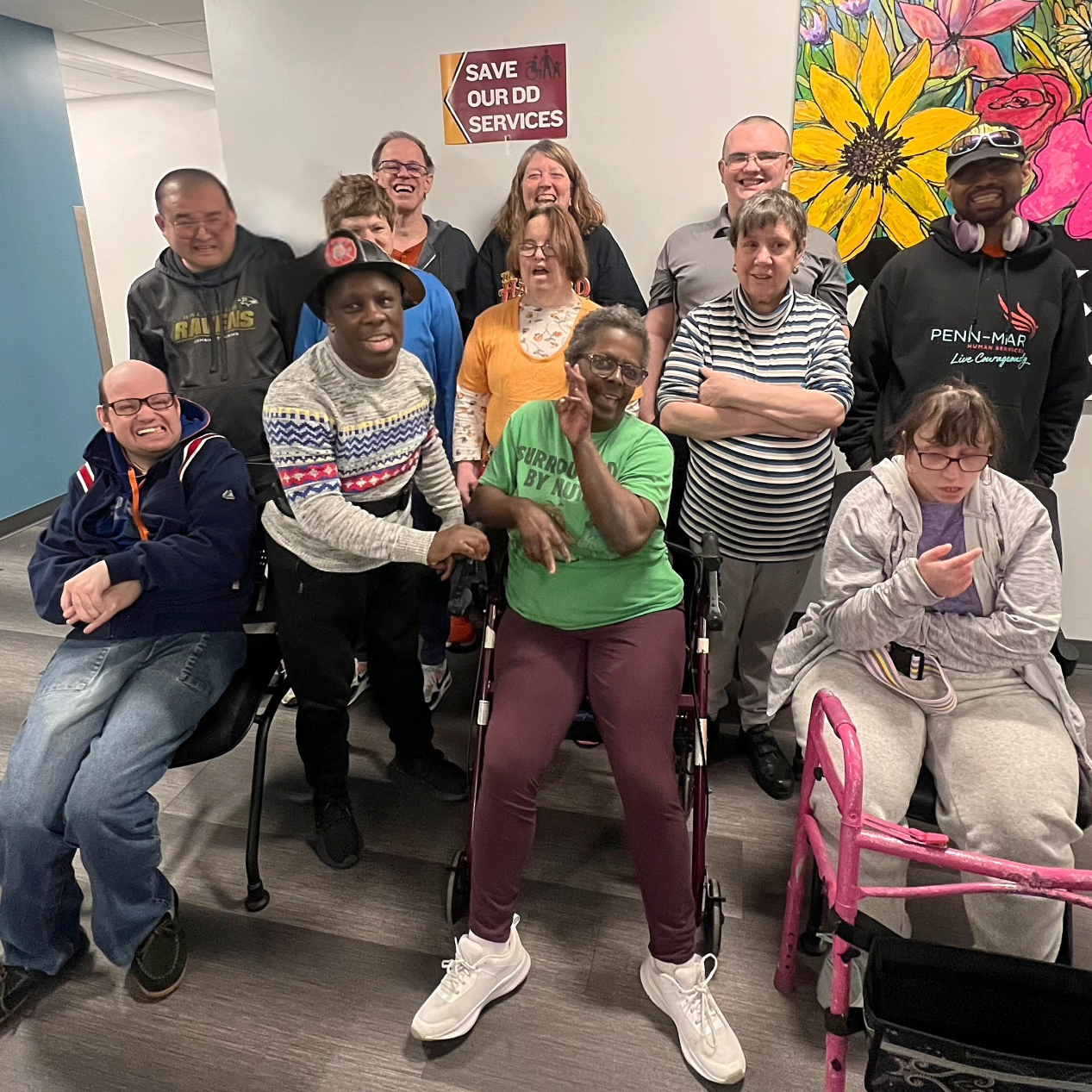 Image of advocates and self advocates with a sign that reads