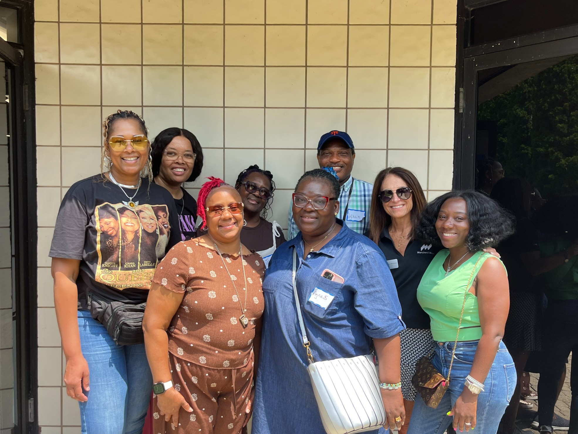 Maryland Works CEO Mary Manzoni poses with Chimes business professionals outside of Maryland works building.