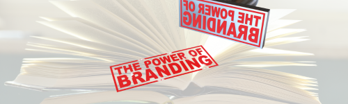 Open book with fanned pages and two red &ldquo;The Power of Branding&rdquo; stamps, one displayed upside down.