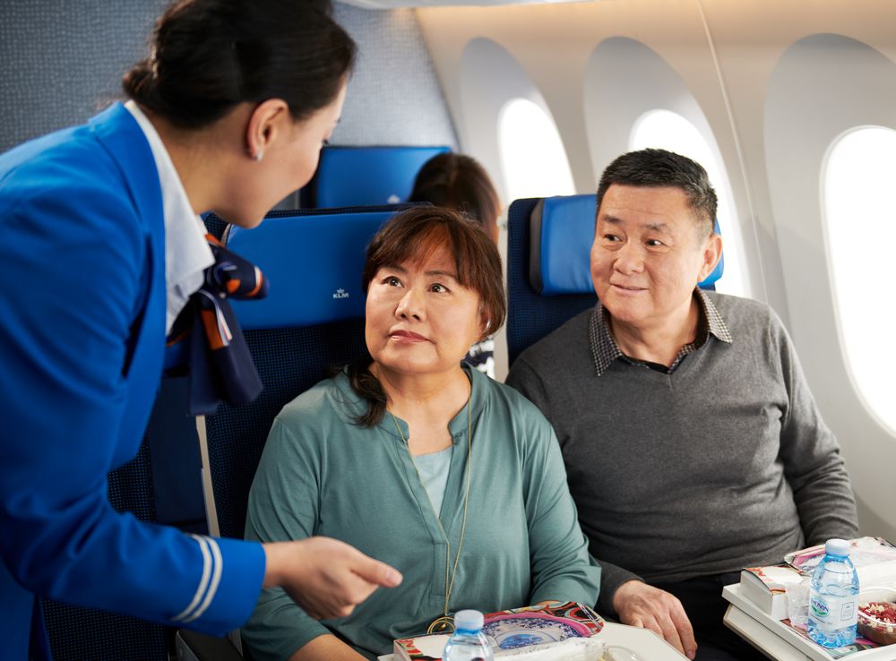 https://stratus.campaign-image.com/images/1199805000037323004_zc_v1_1759976622925_klm_chinese_stewardess_serving_dinner_economy_class.jpg