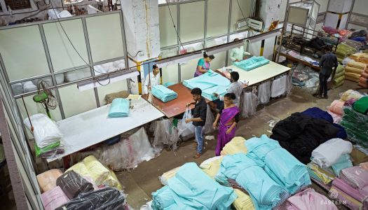 Indian Factory Workers Folding and Wrapping Textiles