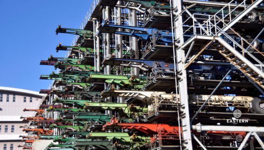 Mechanical multistory parking garage for cargo container chassis