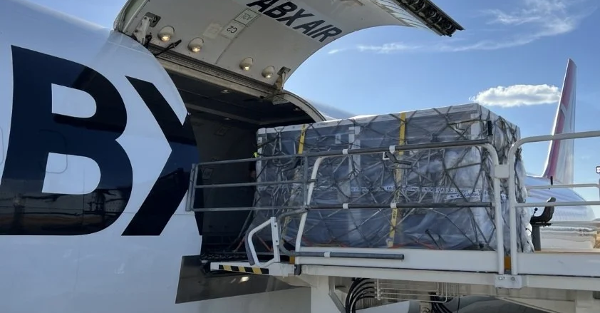 Temperature-controlled pallet shippers being loaded onto an aircraft for a time-critical commercial launch.