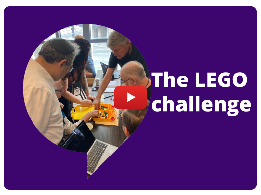 Photo of Mark Gross and others putting together LEGO building blocks