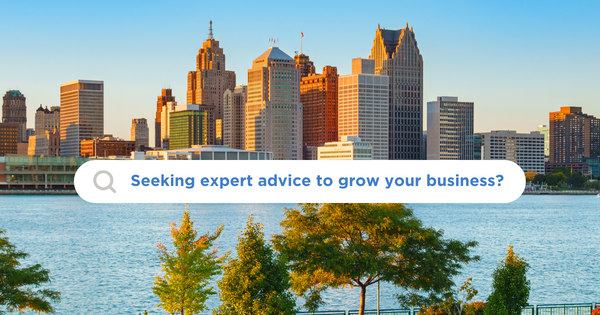 An image of Detroit's skyline and the Detroit River. On top of the image is a search bubble box; inside the box is a magnifying glass icon and text saying