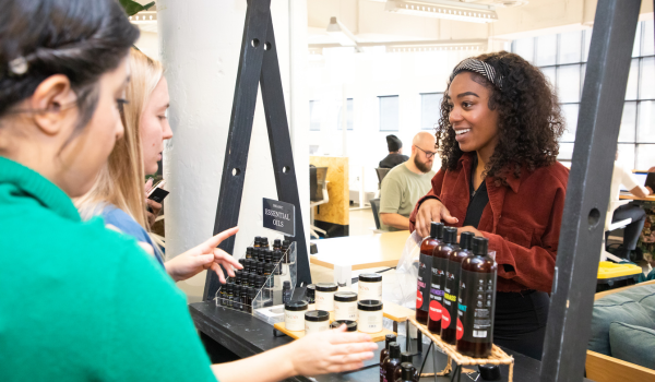 A photo of two people interacting with a vendor at The SHOP