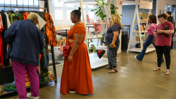 People mingling while looking at various vendor displays from small businesses