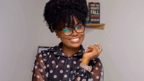 A Black woman smiling for a headshot
