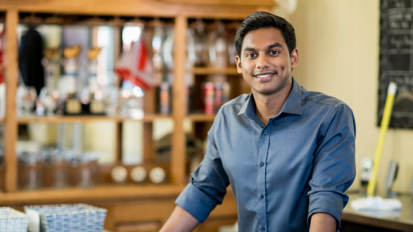 A person inside of a business, smiling for a photo