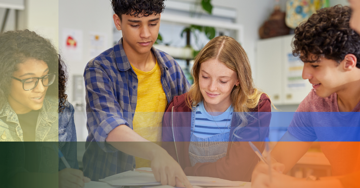 Photo of high school students working collaboratively around a desk.