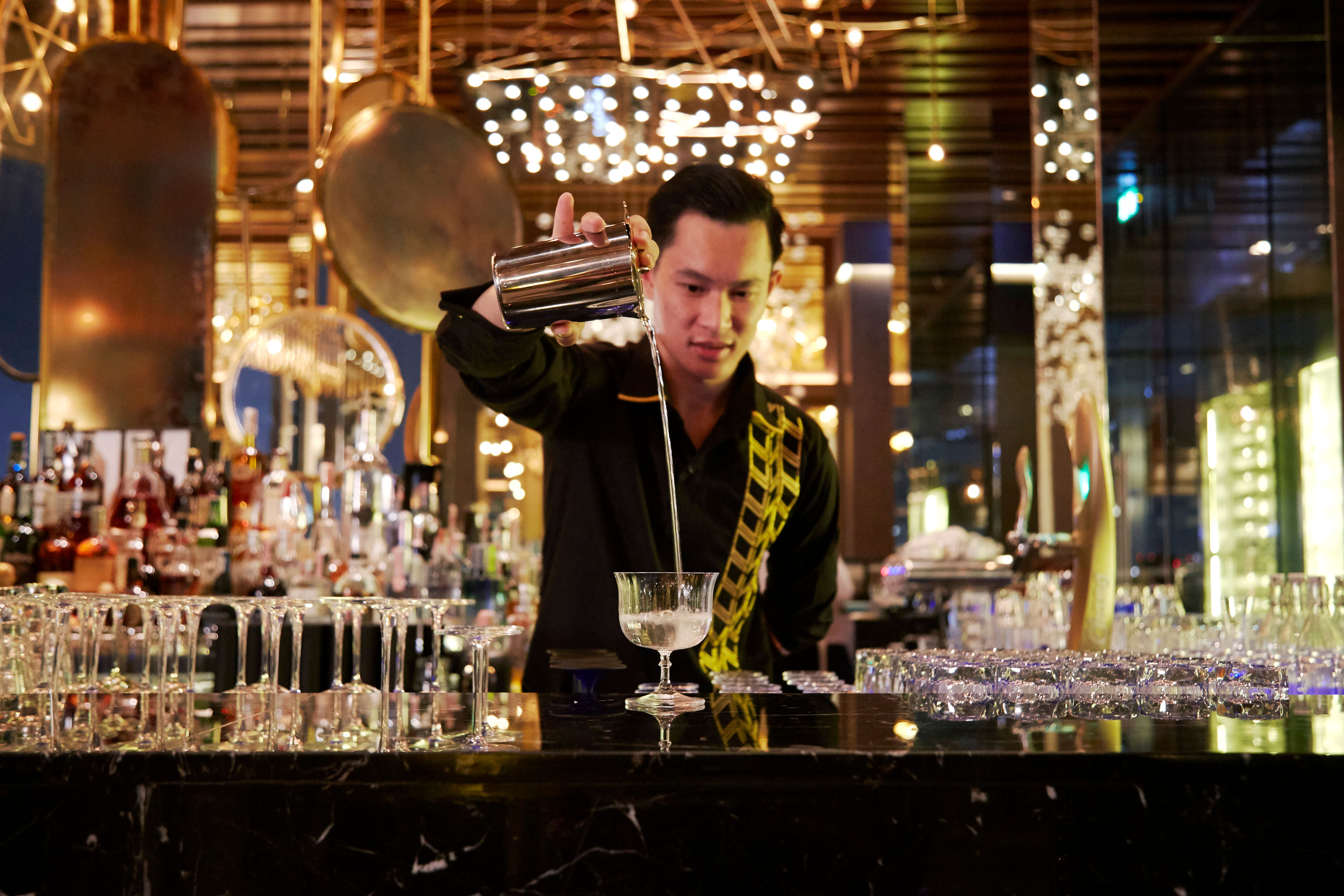 https://stratus.campaign-image.com/images/962061000016431569_zc_v1_1750102879981_avani_plus_riverside_bangkok_hotel_restaurant_seen_bartender_at_the_bar.jpg